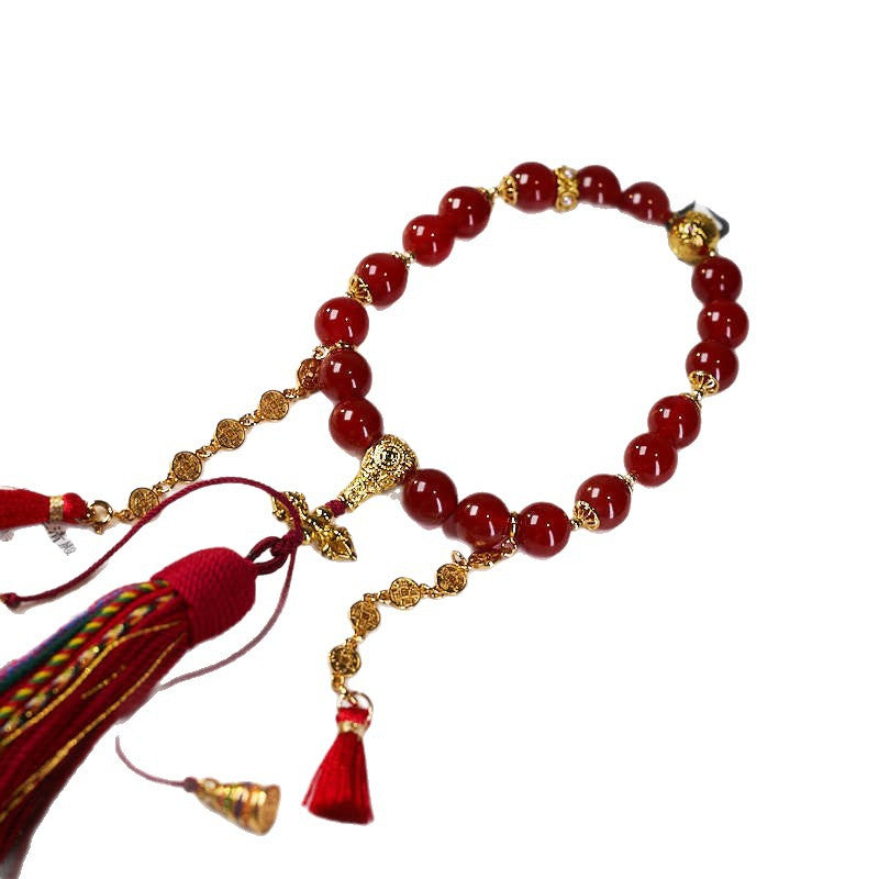 Sacred Buddhist Mala Bracelet with Tibetan craftsmanship, Red Agate Beads for positive energy, and wealth-attracting coin charm